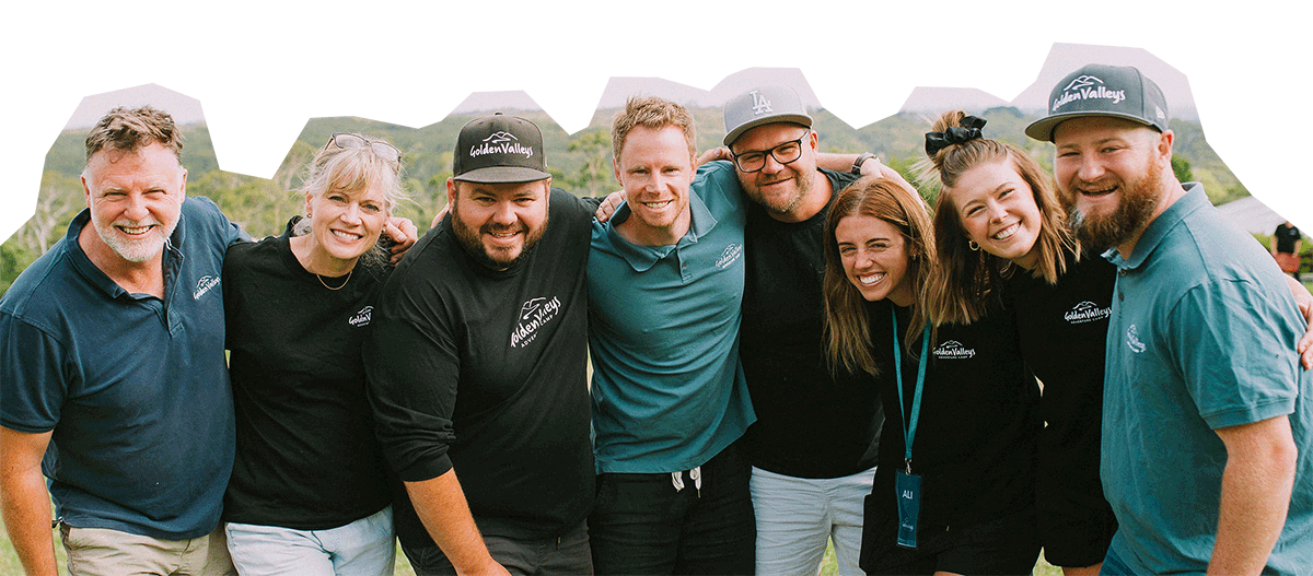 Ignite camps team members standing with arms around each other smiling.